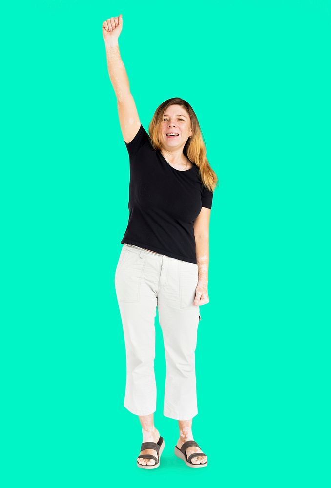 Whole body portrait of a woman with her fist raised
