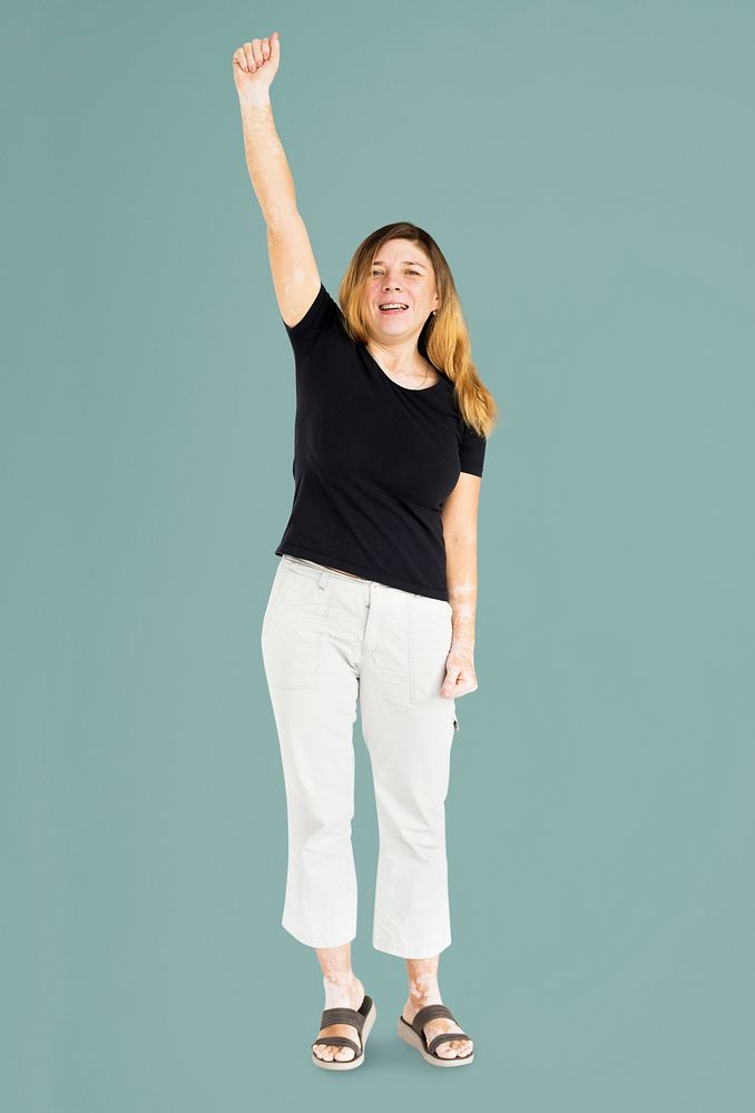 Whole body portrait of a woman with her fist raised