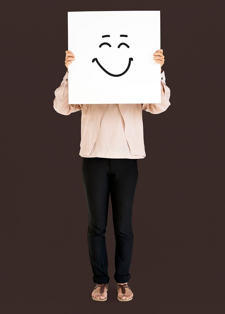 Woman holding banner with smiley face
