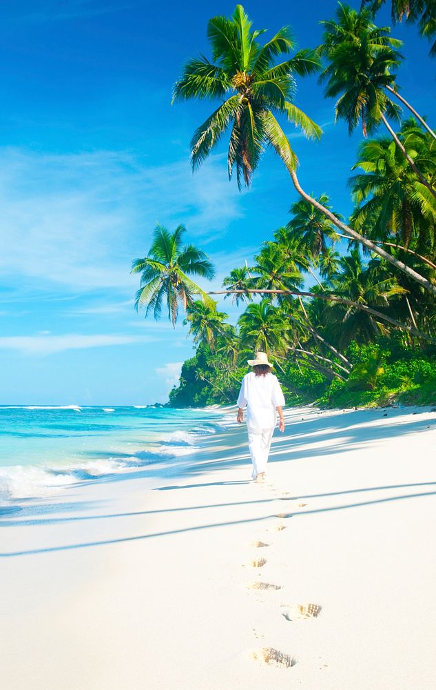 Woman walking on a tropical beach.