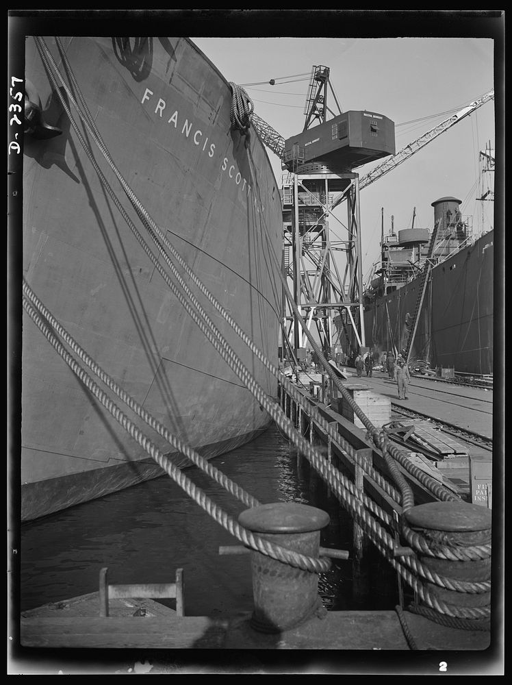 Shipbuilding. "Liberty" ships. Here are two members of the Liberty Fleet lying at anchor in the basin of a large Eastern…