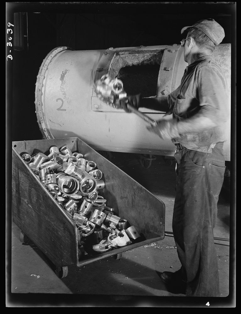 Aluminum casting. Duds, rejected for imperfections, are thrown back into the furnaces for recasting. Location: a large…