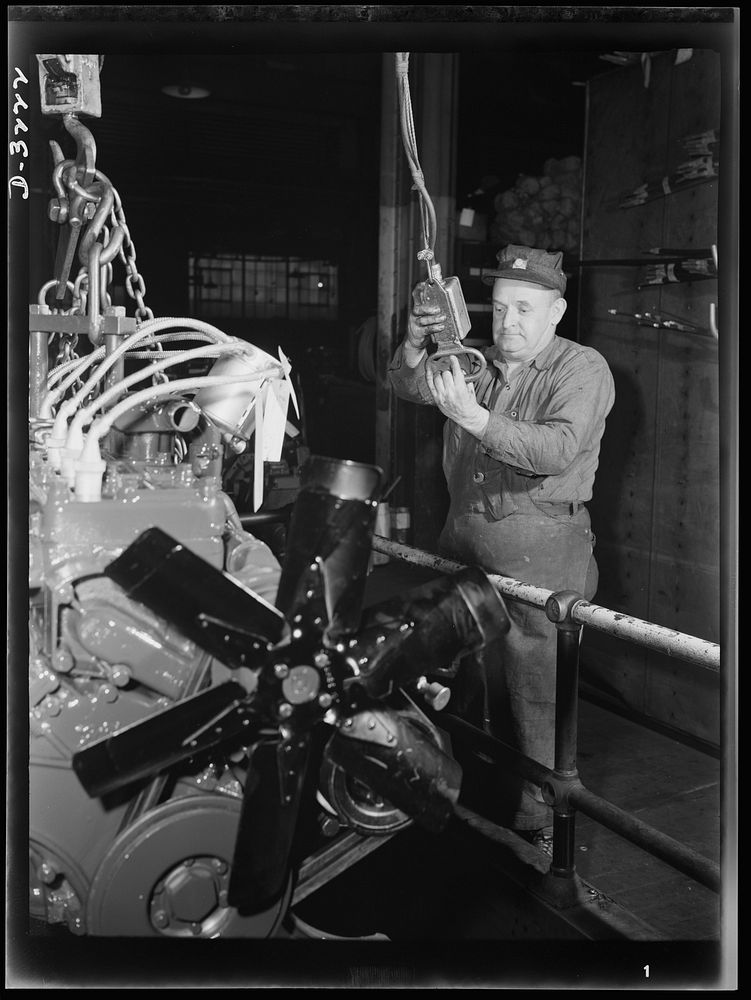 Power for the Army! The engine for an halftrac scout car is raised by electric hoist to the assembly floor of Midwest truck…