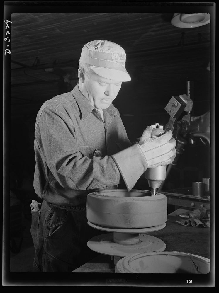 He's preparing rollers for a bogy assembly for a halftrac scout car produced, with many more like it, by a Midwest truck…