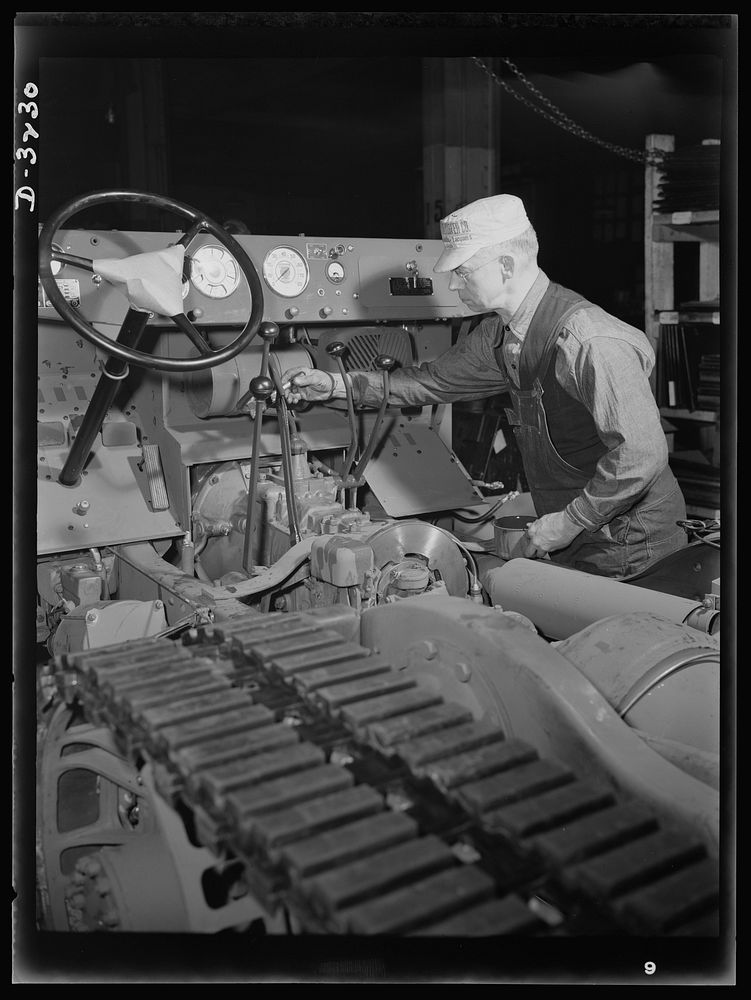 A halftrac scout car gets a touch-up job on the chassis assembly line of an Ohio truck plant. A durable finish protects the…
