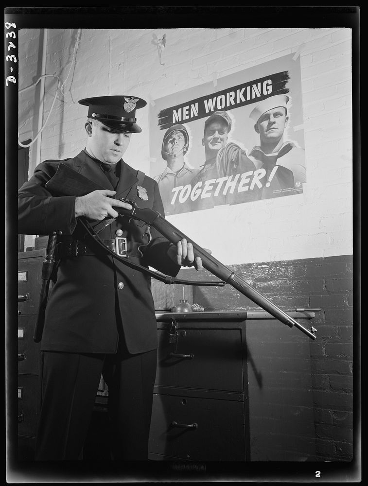 So that men may work together, this sentinel keeps vigil at a large defense plant against saboteurs. White Motor Company…