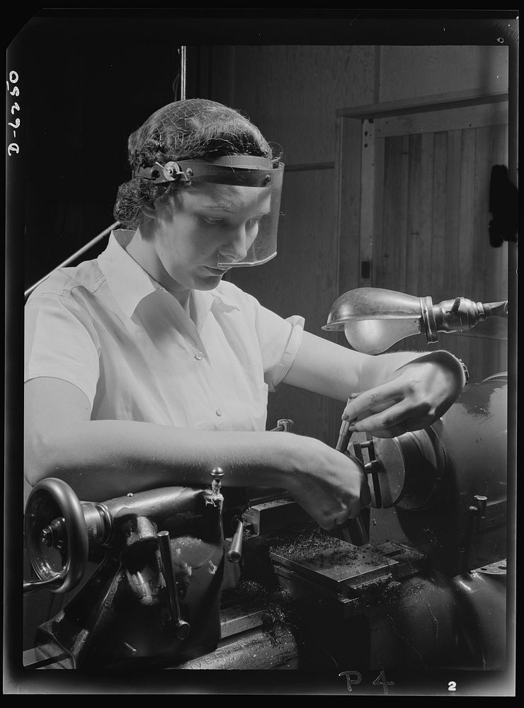 Production. Machine guns of various calibers. Dorothy Taylor, bench lathe operator at a large Eastern firearms plant, makes…