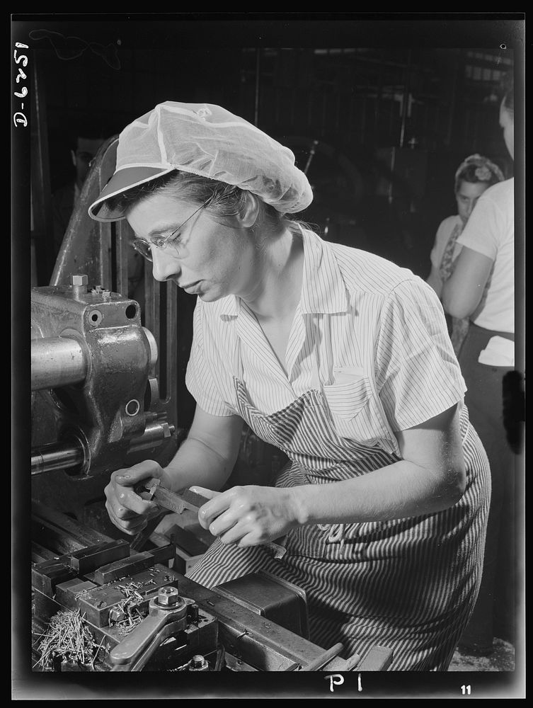 Production. Machine guns of various calibers. Mayna Lentz performs a milling machine operation on the pawl pin of a machine…