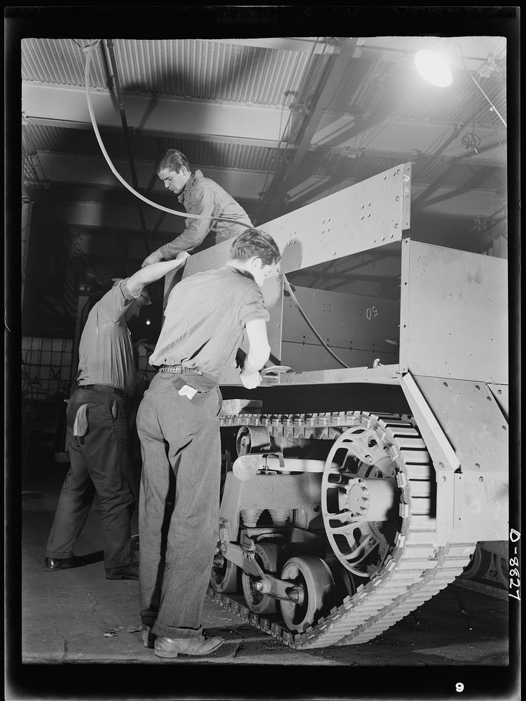 Production. Halftrac armoured cars. Attaching body parts to a halftrac scout car in the converted Eastern plant of a lock…