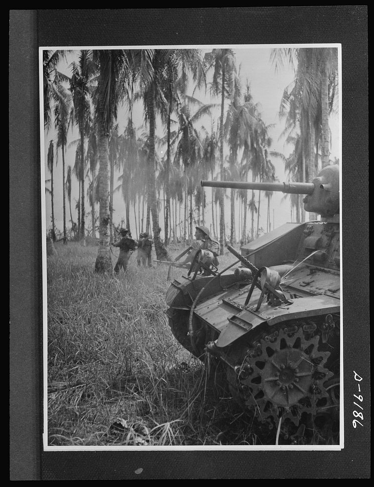 Australian fighting forces in action at Papua. Infantrymen advance as an Australian-manned American tank blast Japanese…