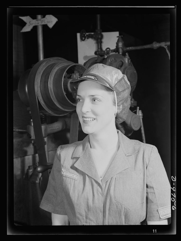 Safe clothes for women war workers. Her hair tucked away under a safety cap, war worker Eunice Kimball stands beside…