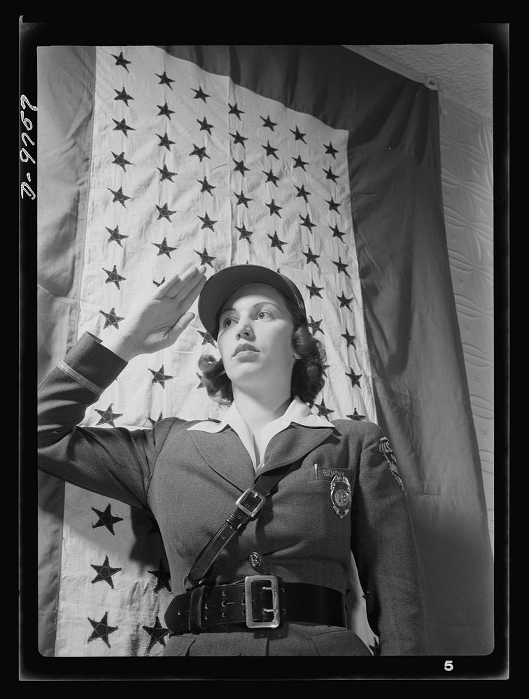 Safe clothes for women war workers. Estelle Hendel, twenty-eight, a guard at the Bendix Aviation Plant in Brooklyn, stands…