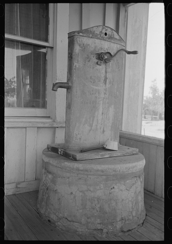[Untitled photo, possibly related to: Enclosed well and chain pump on porch of ranch house near Spur, Texas] by Russell Lee