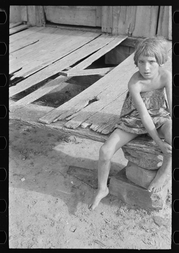 [Untitled photo, possibly related to: Daughter of agricultural day laborer on porch of her home, McIntosh County, Oklahoma]…