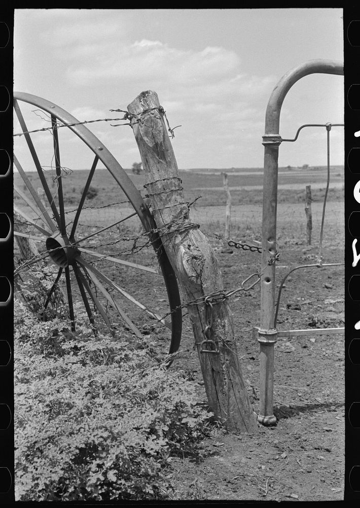 Detail of fence and gate construction of  tenant farmer south of Muskogee, Oklahoma. This farm is owned by an out- of-state…