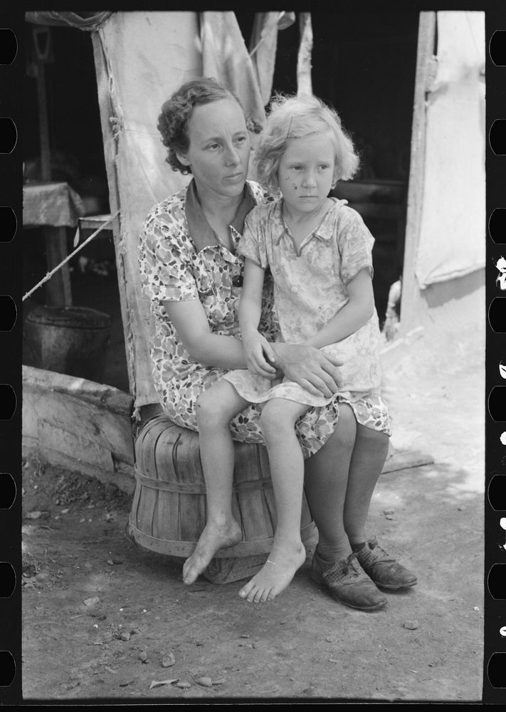Mother and child of agricultural day laborers family encamped near Spiro. Sequoyah County, Oklahoma by Russell Lee