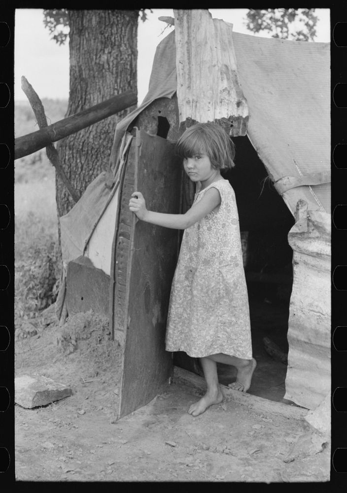 Child of agricultural day laborer coming out of tent near Spiro. Sequoyah County, Oklahoma by Russell Lee
