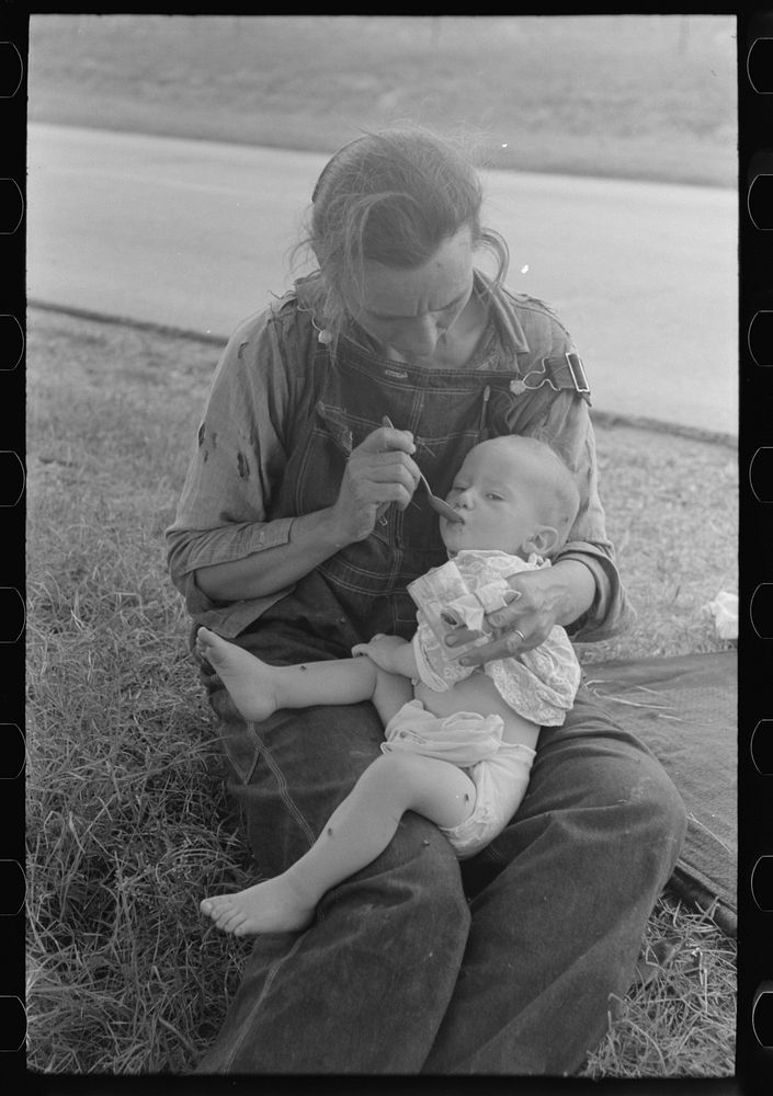 Migrant mother feeding her baby while the family was stopped by the roadside for lunch, east of Fort Gibson, Muskogee…