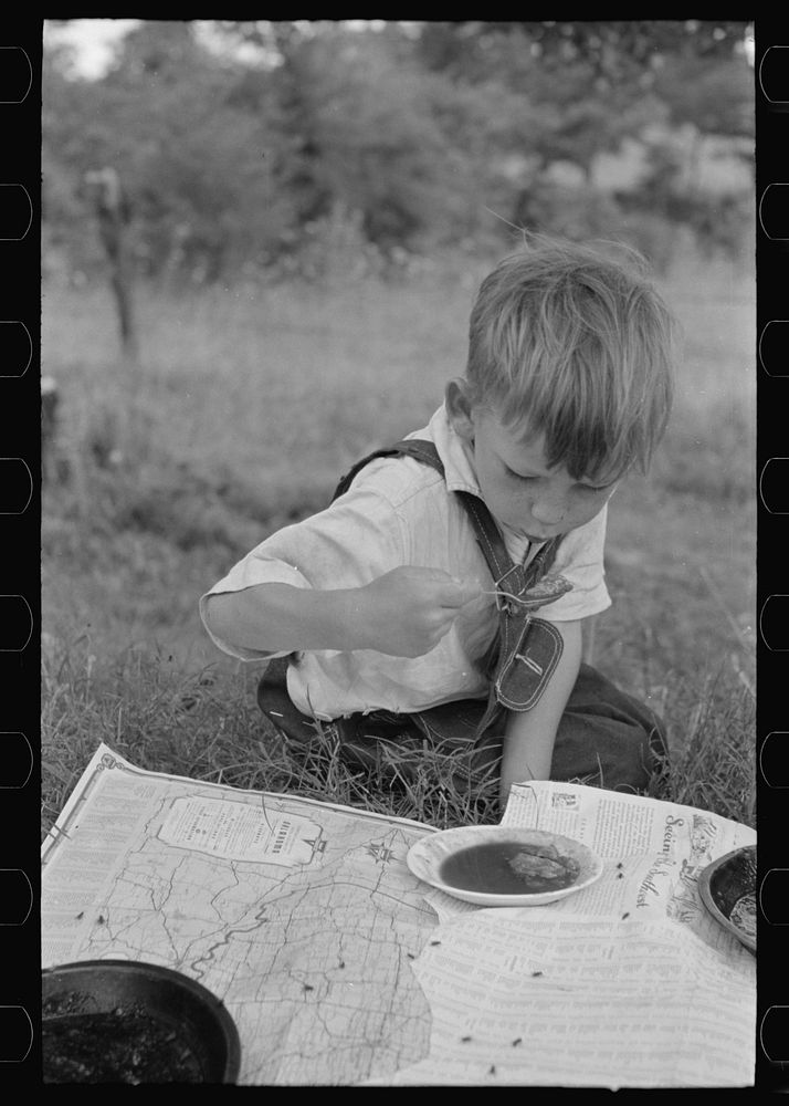 Son of white migrant eating lunch of berry pie along the highway east of Fort Gibson, Oklahoma by Russell Lee