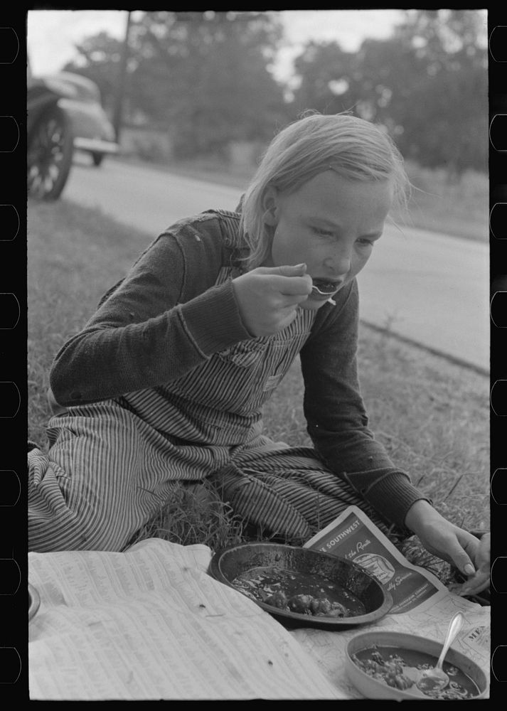 Daughter of white migrant eating lunch along the highway east of Fort Gibson, Muskogee County, Oklahoma by Russell Lee