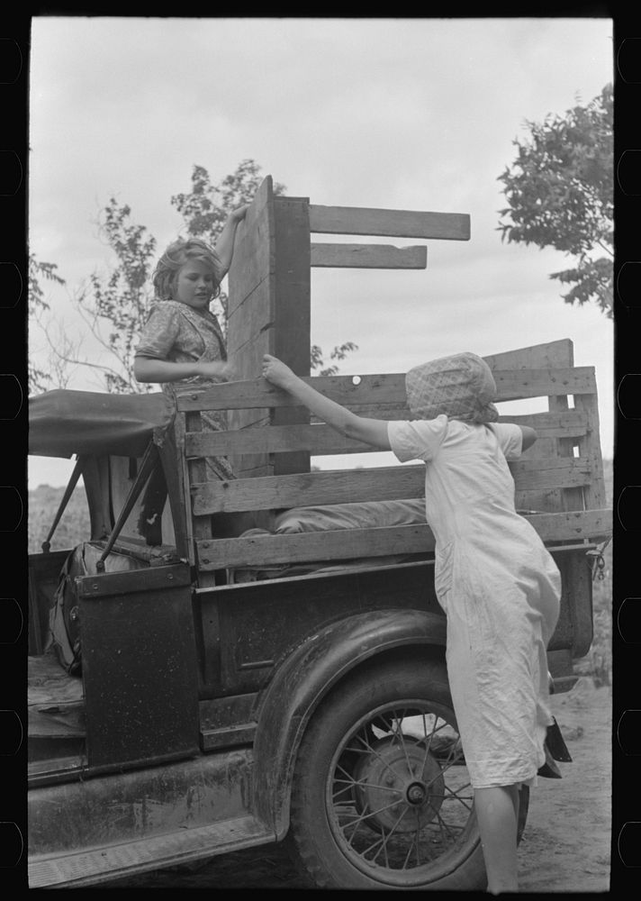 Loading truck with table which will be carried by this migrant family to California near Muskogee, Oklahoma by Russell Lee
