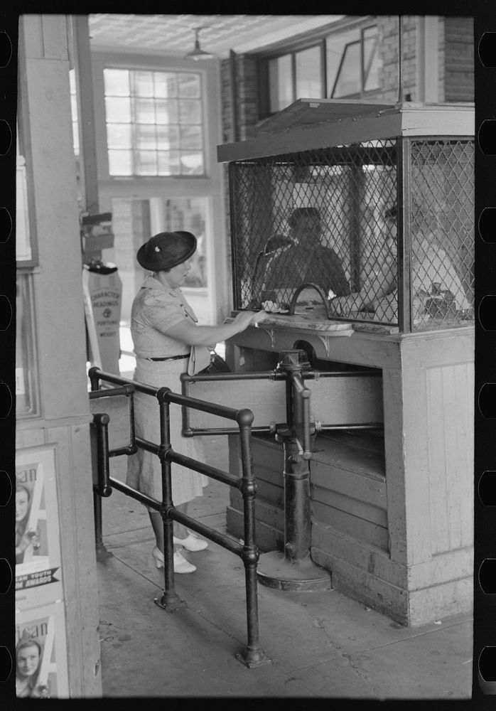 Woman buying ticket at gate. Streetcar terminal, Oklahoma City, Oklahoma by Russell Lee