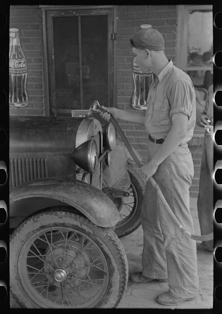 Filling radiator of migrant car with water. This is done frequently, as these radiators usually leak. Near Henrietta [i.e.…