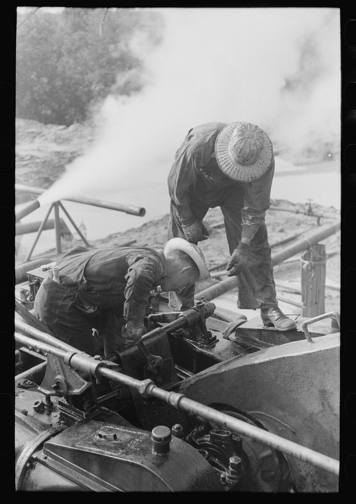 [Untitled photo, possibly related to: Roughnecks working on engine, Seminole oil field, Oklahoma] by Russell Lee