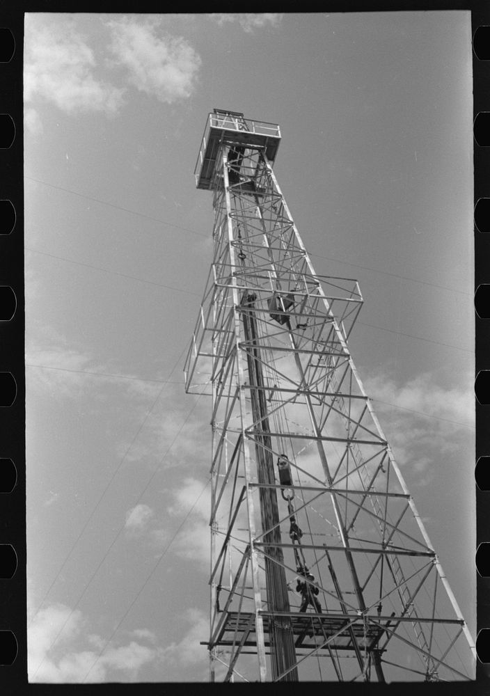 [Untitled photo, possibly related to: Oil derrick, Oklahoma City, Oklahoma. Workers are pulling out pipe] by Russell Lee