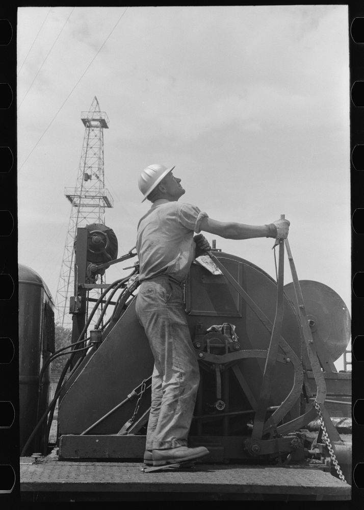 [Untitled photo, possibly related to: Winch operator at oil well in Oklahoma City, Oklahoma] by Russell Lee
