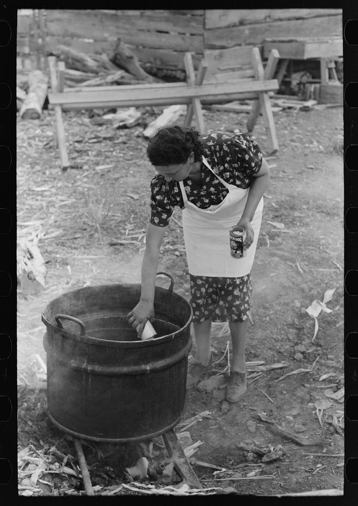 Adding lye to grease in soap making, Spanish-American FSA (Farm Security Administration) client, Taos County, New Mexico by…