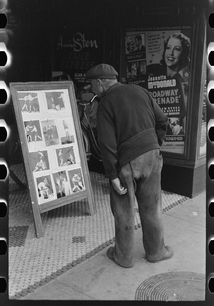[Untitled photo, possibly related to: Old man looking at stills of Joe Lewis fight picture, Windsor Locks, Connecticut] by…