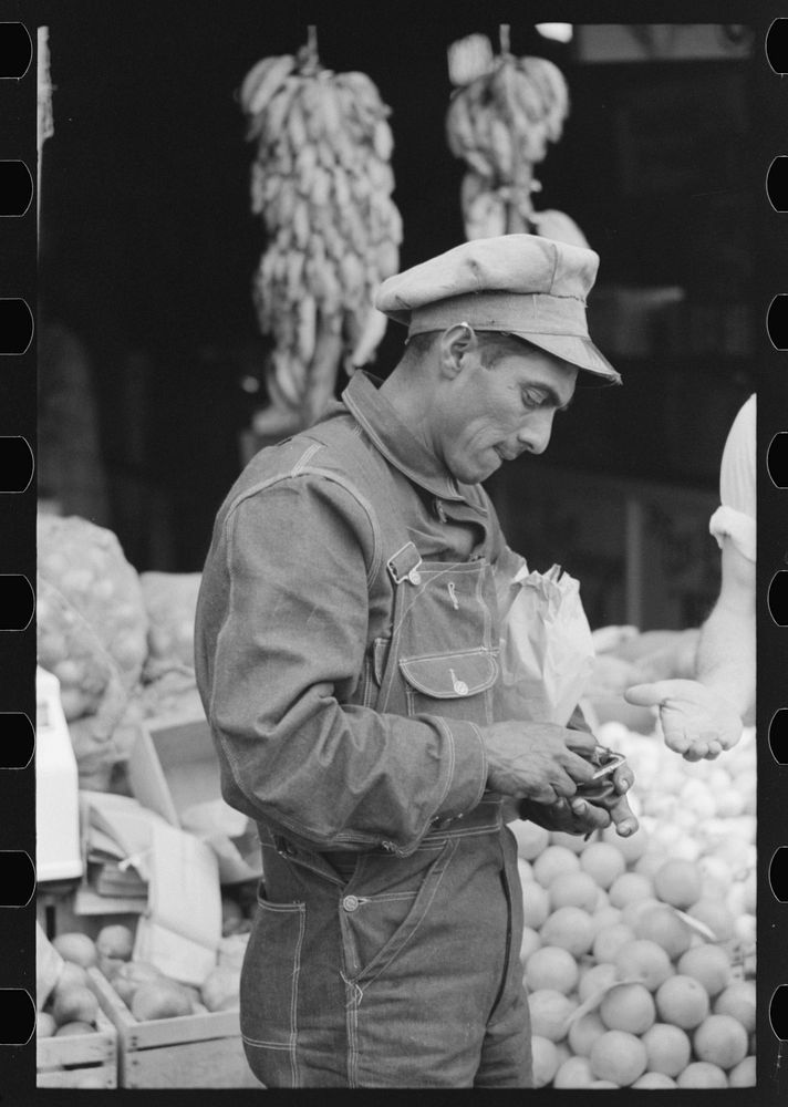 Mexican worker paying for merchandise, market square, Waco, Texas by Russell Lee