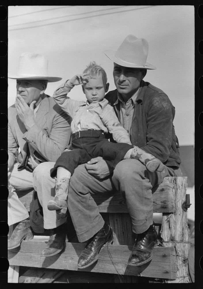 West Texan and his son sitting on fence at horse auction, Eldorado, Texas by Russell Lee