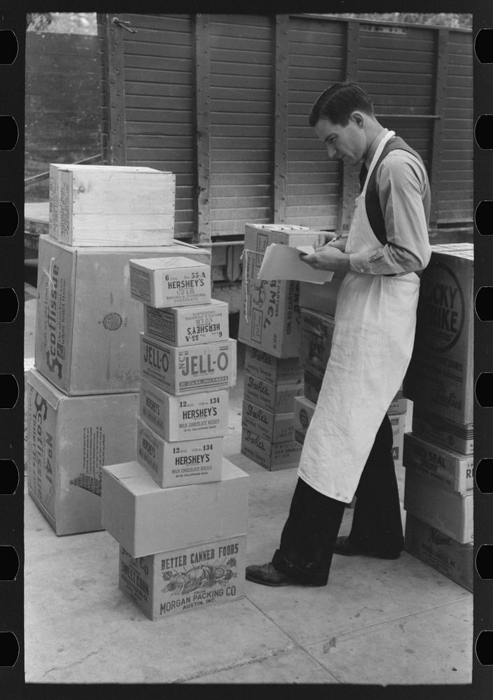 Checking delivery of supplies from wholesale grocery store, San Angelo, Texas by Russell Lee