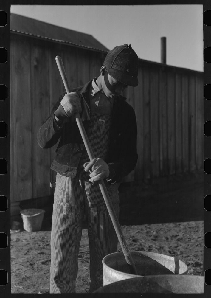 [Untitled photo, possibly related to: Son of Pomp Hall,  tenant farmer, carrying can full of mash to hogpen, Creek County…