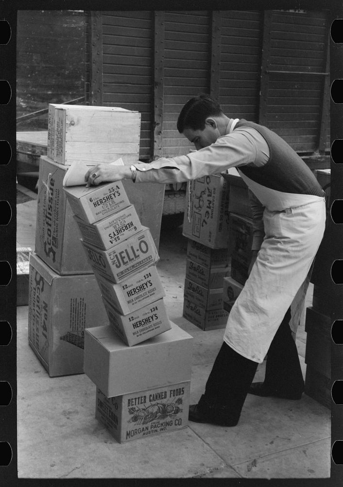 Checking delivery of supplies from wholesale grocery store, San Angelo, Texas by Russell Lee