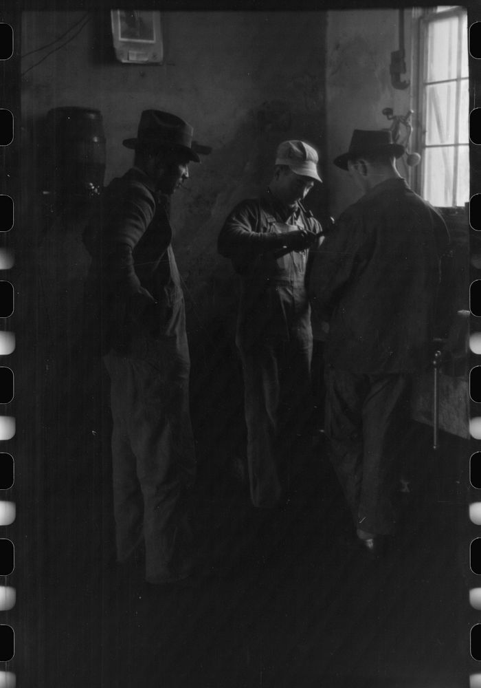 [Untitled photo, possibly related to: Pomp Hall,  tenant farmer, talking to another farmer as he waits at the smith shop in…