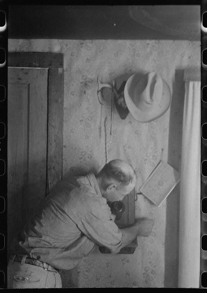 West Texas ranchman making a telephone call, Kimble County, Texas by Russell Lee