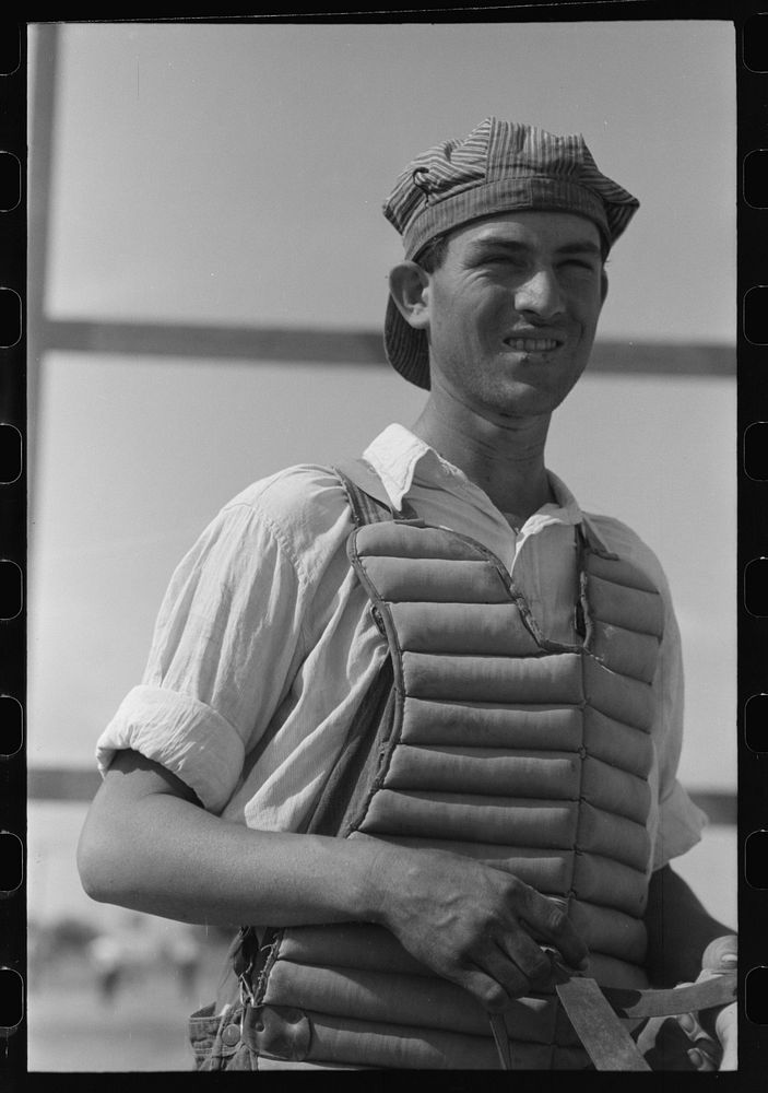 Migratory laborers like to play baseball. Here is one of them in a catchers uniform at the Agua Fria Migratory Labor Camp…