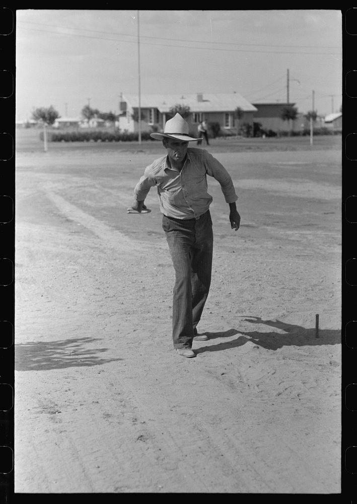 Pitching horseshoes at the Agua Fria Migratory Labor Camp, Arizona by Russell Lee