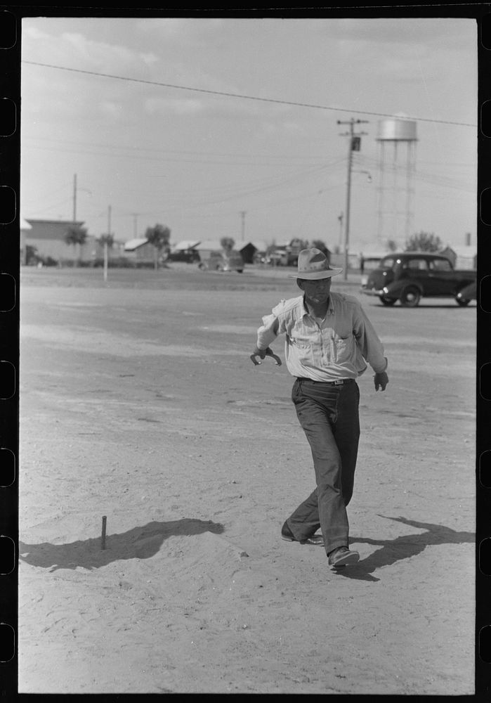 [Untitled photo, possibly related to: Pitching horseshoes at the Agua Fria Migratory Labor Camp, Arizona] by Russell Lee