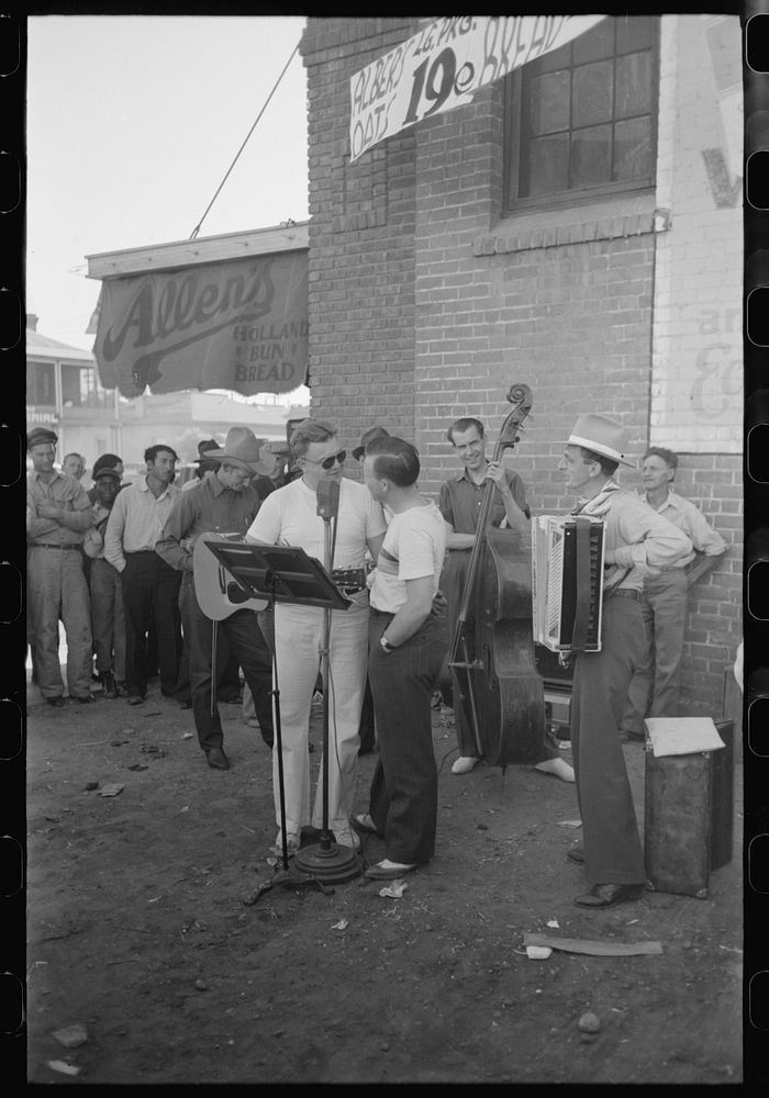 [Untitled photo, possibly related to: Orchestra playing outside a grocery store on Saturday afternoon which is designed to…