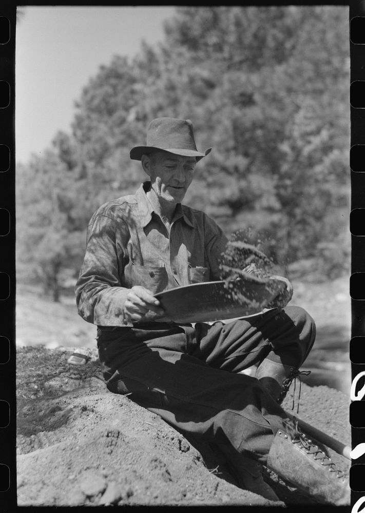 Prospector panning gold by dry method. Pinos Altos, New Mexico by Russell Lee