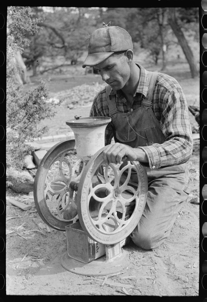 Jack Whinery grinding pinto beans for chicken feed, Pie Town, New Mexico by Russell Lee