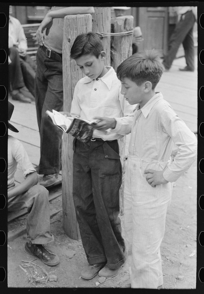 Children of gold miners looking at the comics, Mogollon, New Mexico by Russell Lee