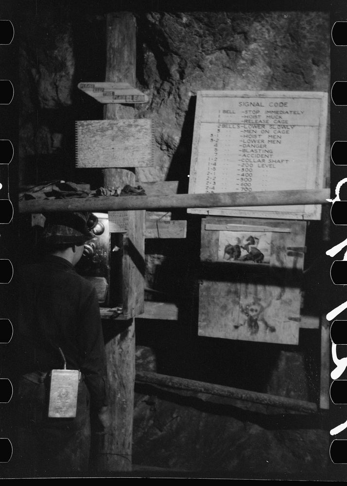 [Untitled photo, possibly related to: Miner using telephone at 500-foot level at gold mine. Mogollon, New Mexico] by Russell…