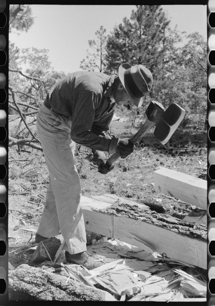Using a broad axe in hewing ties, Pie Town, New Mexico by Russell Lee