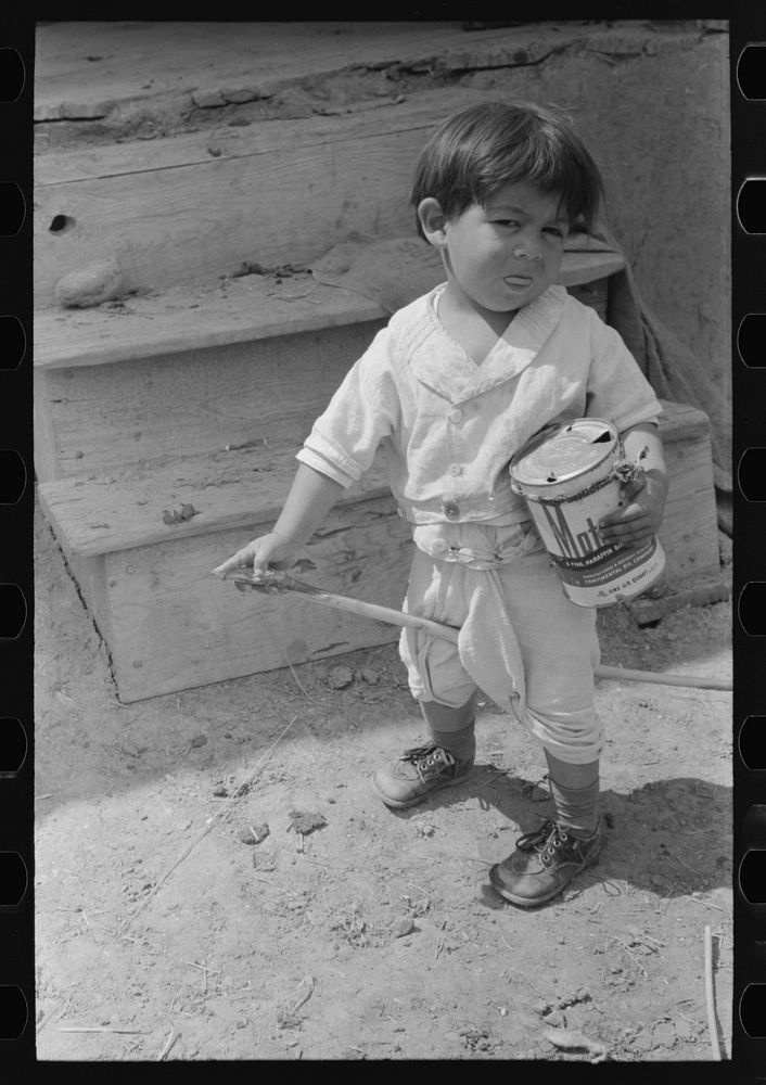 Spanish-American boy playing horse, Chamisal, New Mexico by Russell Lee