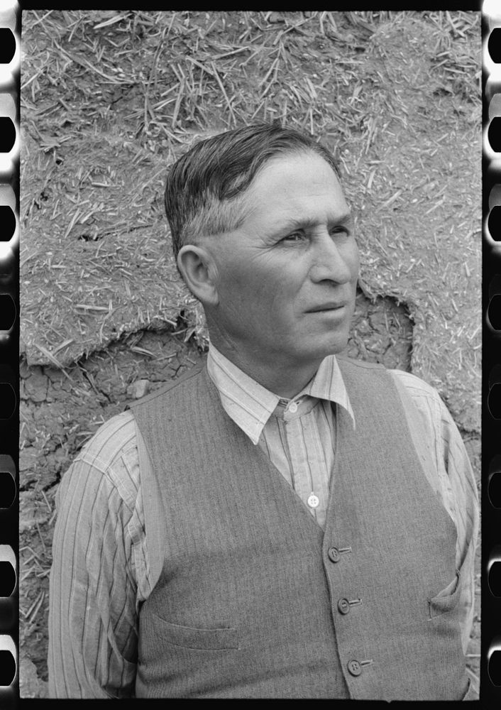 [Untitled photo, possibly related to: Spanish-American farmer standing in front of adobe wall, Chamisal, New Mexico] by…